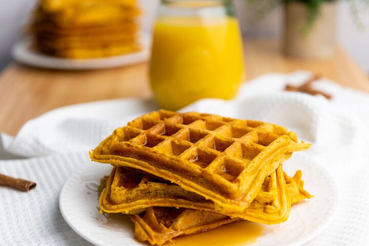 best ever pumpkin spice waffle recipe, pumpkin waffles on a white plate