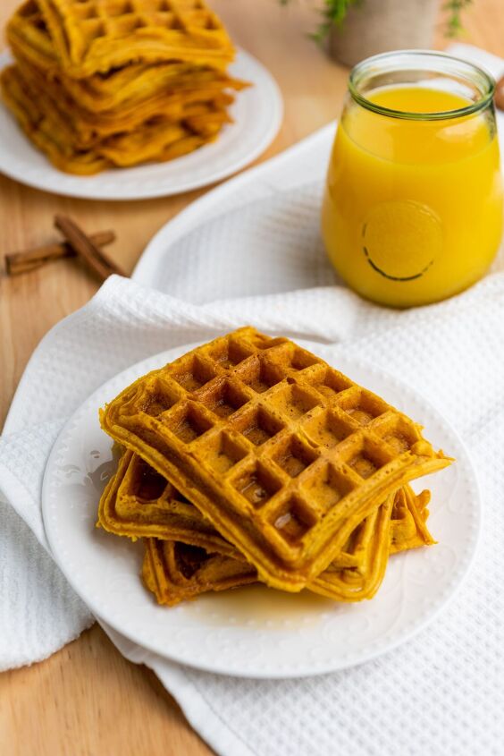 best ever pumpkin spice waffle recipe, pumpkin pie waffles on a white plate