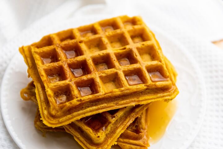 best ever pumpkin spice waffle recipe, pumpkin spice waffles on a white plate