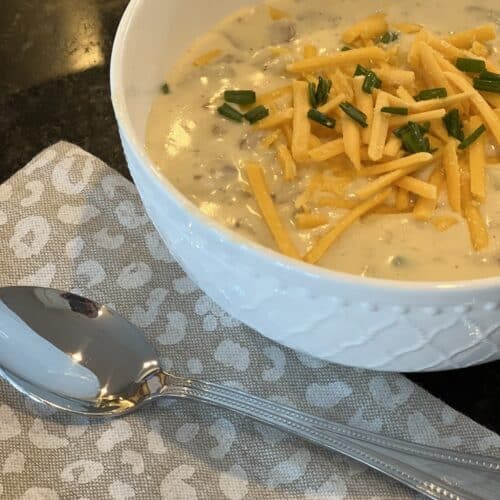 how to the best sweet potato clam chowder recipe, chopped chives shredded dairy free cheese soup bowl tea spoon beige linen napkin