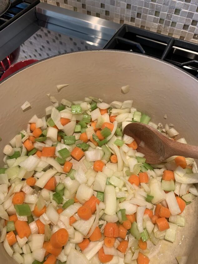 delicious ten vegetable soup, Here is the collection of chopped carrots onions and celery getting sauteed in olive oil on the stove