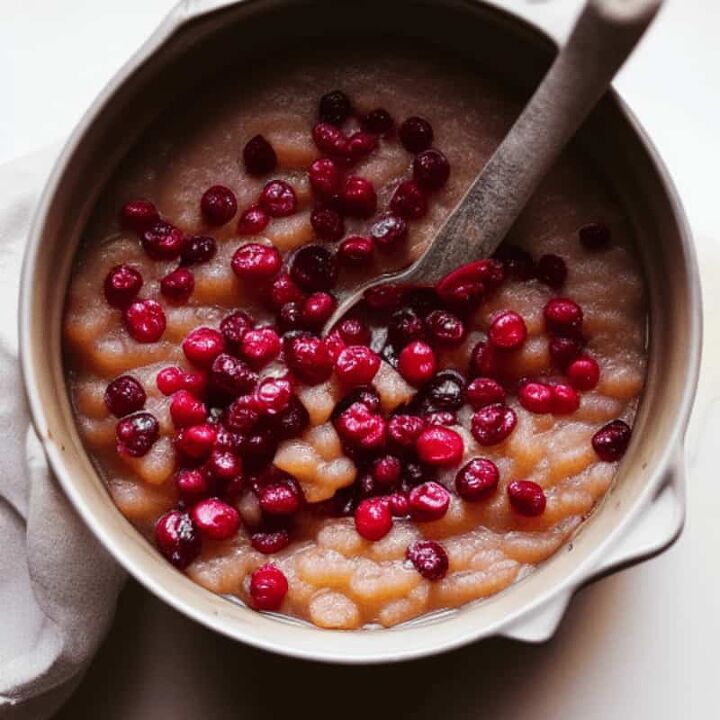 chunky applesauce recipe with cranberries, a pot with applesauce and cranberries in it