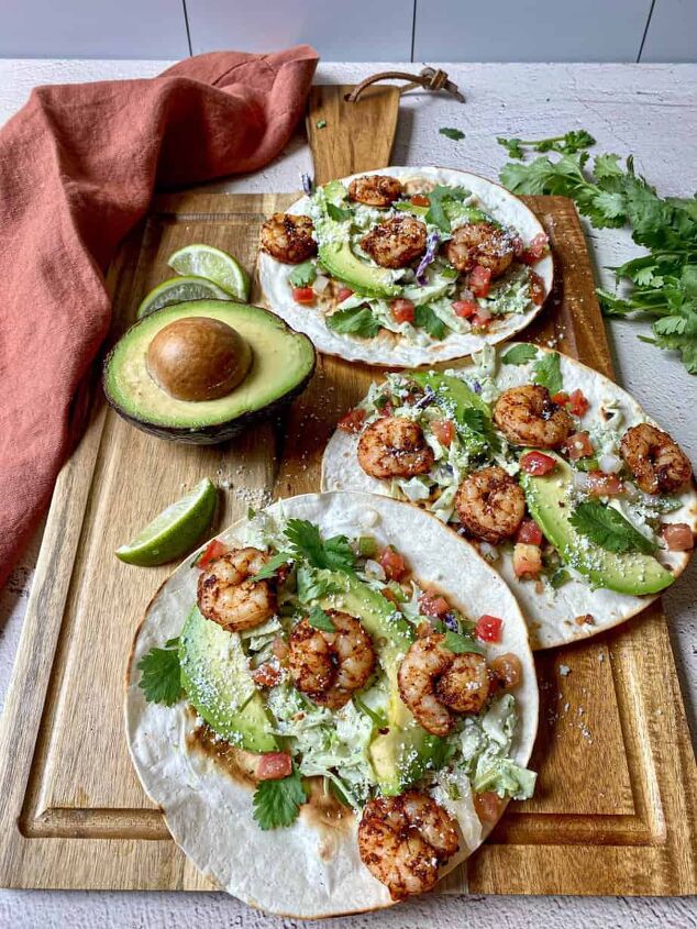 air fryer shrimp tacos with slaw happy honey kitchen, Three air fryer shrimp tacos with slaw on a cutting board with an avocado cilantro and lime wedges
