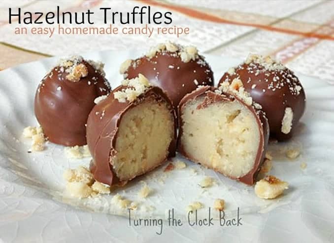 hazelnut marzipan truffles on a white plate with text overlay hazelnut truffles an easy homemade candy recipe