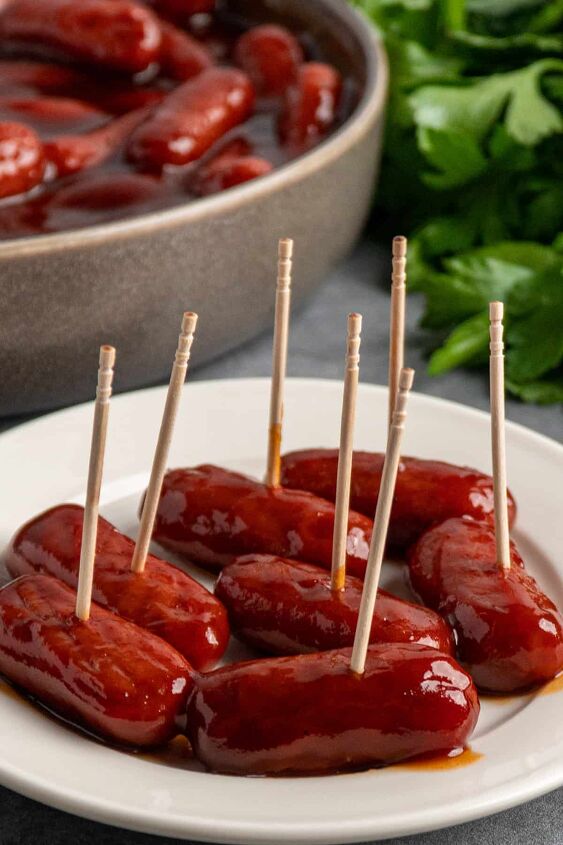 crock pot little smokies, Crock pot little smokies on a white plate with toothpicks in them and more in a bowl in the background