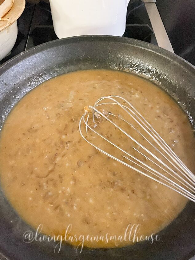 the best ever homemade swedish meatballs recipe, swedish meatball sauce in fry pan before pouring it over pan fried meatballs