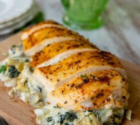 spinach artichoke stuffed chicken, overhead view of sliced chicken with spinach and artichokes in the middle