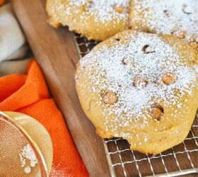 Giant Soft Pumpkin Cookies dusted with powdered sugar on wire rack