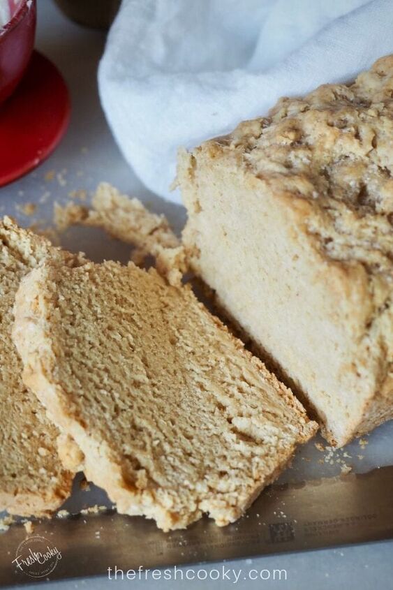 easy 4 ingredient beer bread, Close up of beer bread with two pieces sliced on a cutting board with serrated knife