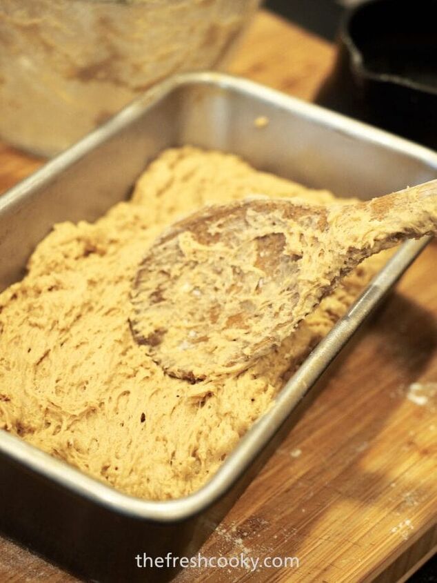 easy 4 ingredient beer bread, Using a wooden spoon to smooth the top of beer bread batter into a loaf pan