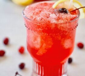 easy cranberry spritzer by the glass or pitcher, Pretty glass filled with bright red Cranberry Spritzer with cherries