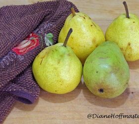 caramel vanilla pear sauce recipe, fresh pears on a wood cutting board with a kitchen towel