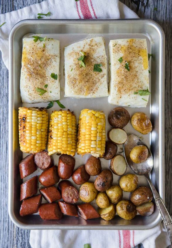 sausage sheet pan dinner, halibut corn sausage and potatoes on a silver baking tray