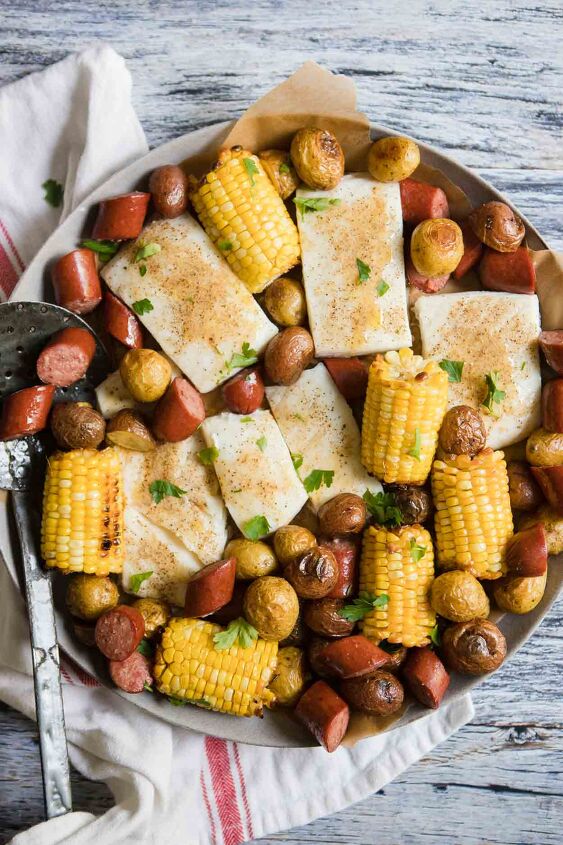 sausage sheet pan dinner, close up of a round platter filled with corn sausage halibut and potatoes