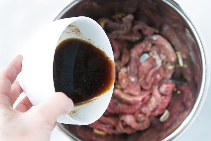 instant pot beef and broccoli, Pouring beef and broccoli sauce into the Instant Pot