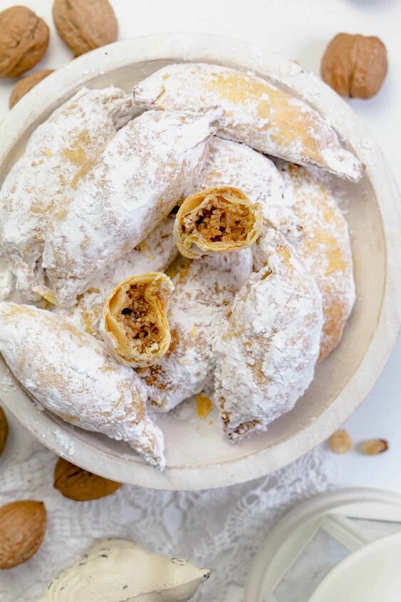 polish christmas cookies kifli, Sugar coated kifli on a serving plate with one broken in half to show the filling