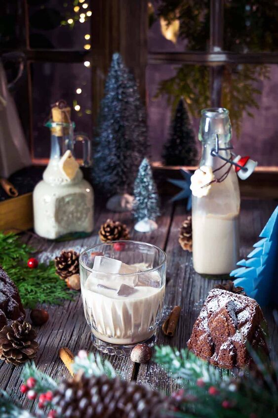 christmas homemade baileys, Homemade Christmas Baileys in pretty bottles and a glass on a festive decorated table