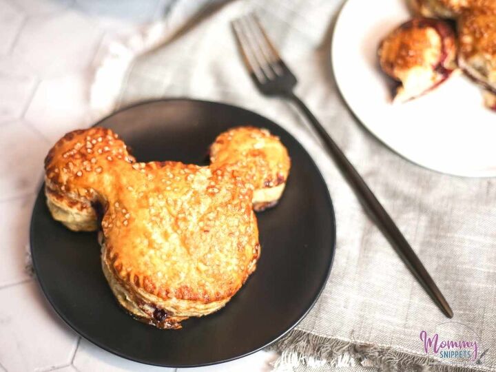 an easy puff pastry cherry turnover recipe for mickey mouse fans, Puff Pastry Cherry Turnover on a Black Dessert Plate