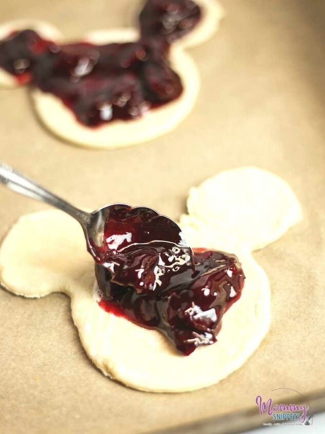an easy puff pastry cherry turnover recipe for mickey mouse fans, scooping chrry filling into the center of the turnovers pastry