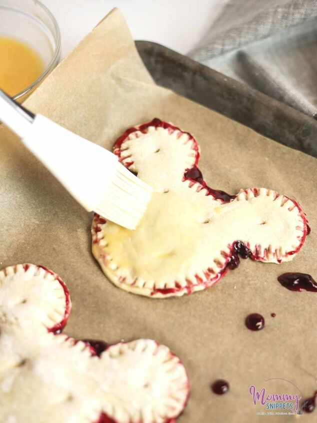 an easy puff pastry cherry turnover recipe for mickey mouse fans, covering each cherry turnover with egg wash before popping them into the oven