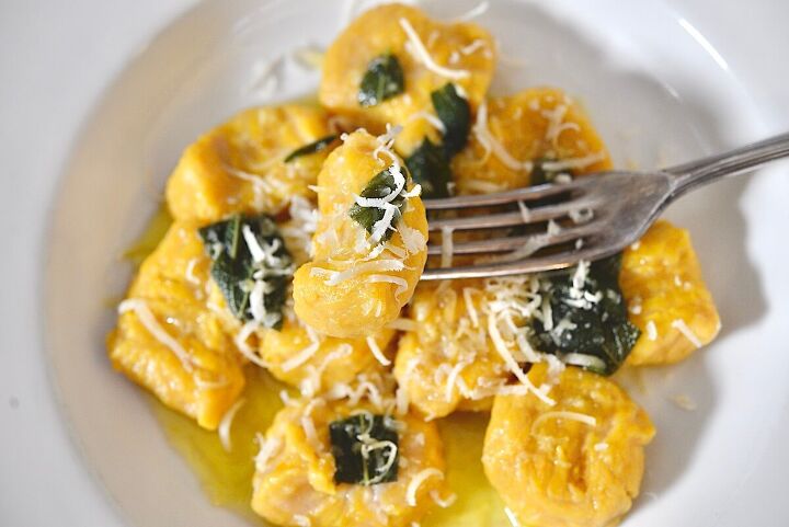 easy pumpkin gnocchi with sage brown butter sauce , homemade pumpkin gnocchi with sage brown butter sauce on a fork