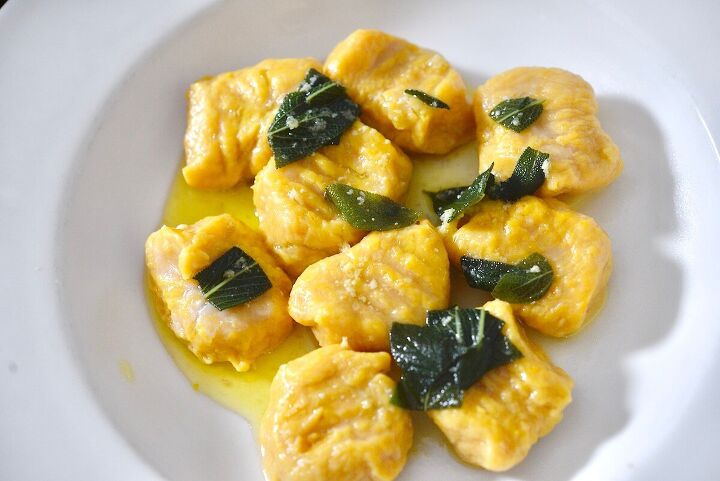 easy pumpkin gnocchi with sage brown butter sauce , pumpkin gnocchi with sage brown butter sauce on plate