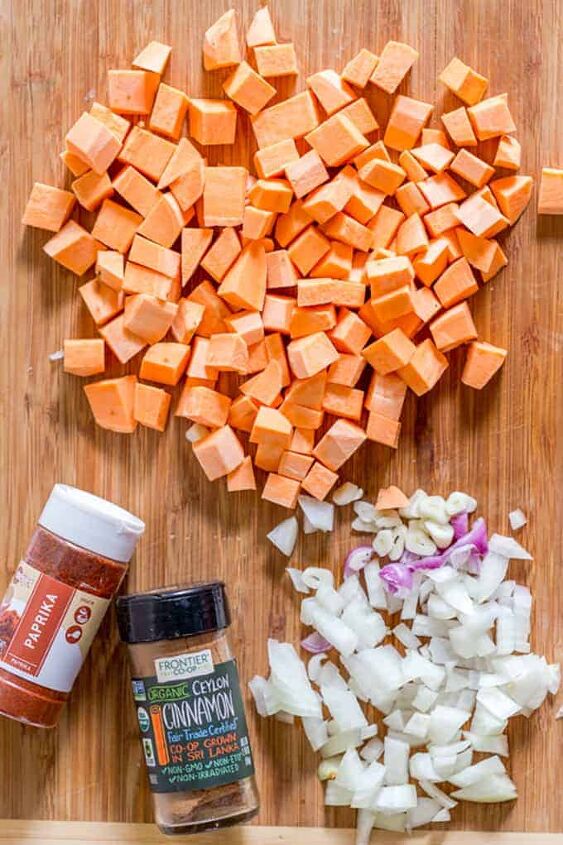 creamy sweet potato soup, A wooden cutting board with cubes of sweet potato