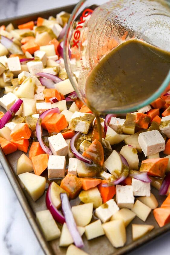 roasted root vegetables with tofu, A sheet pan filled with root vegetables being drizzled with a savory dressing before baking