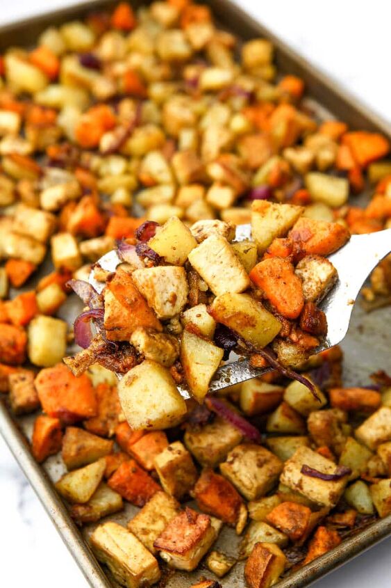 roasted root vegetables with tofu, A spatula full of roasted root veggies held above a sheet pan