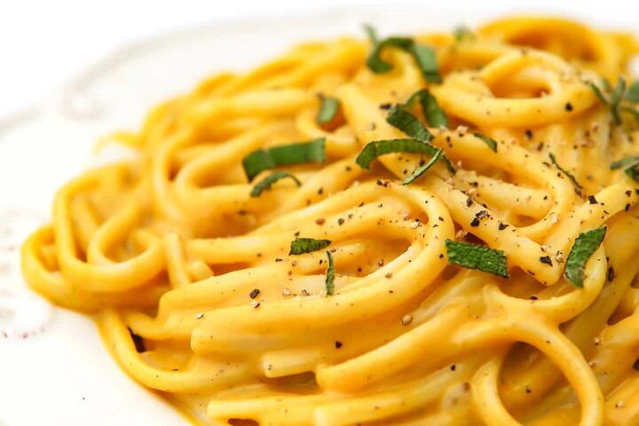 vegan pumpkin pasta, A close up of vegan pumpkin pasta with fresh sage sprinkled on top