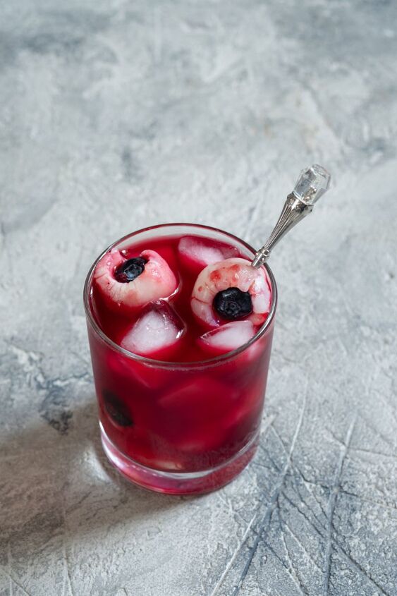 sip slurp and shiver devilishly delicious halloween drink recipes, Blueberry Lychee Eyeball Cocktail