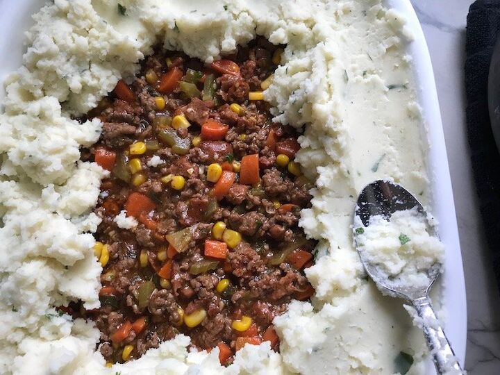 easy cottage pie recipe with chorizo, Covering filling with potatoes for Cottage Pie recipe It has Spanish Chorizo and ground beef cooked in a rich and savory gravy with veggies and herbs Creamy mashed potatoes sit on top with manchego parmesan and garlic dinnerideas cottagepie shepherdspie