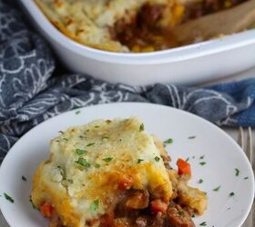 easy cottage pie recipe with chorizo, Piece of Cottage Pie on plate with dish in back This recipe has Spanish Chorizo and ground beef cooked in a rich and savory gravy with veggies and herbs Creamy mashed potatoes sit on top with manchego parmesan and garlic dinnerideas cottagepie shepherdspie