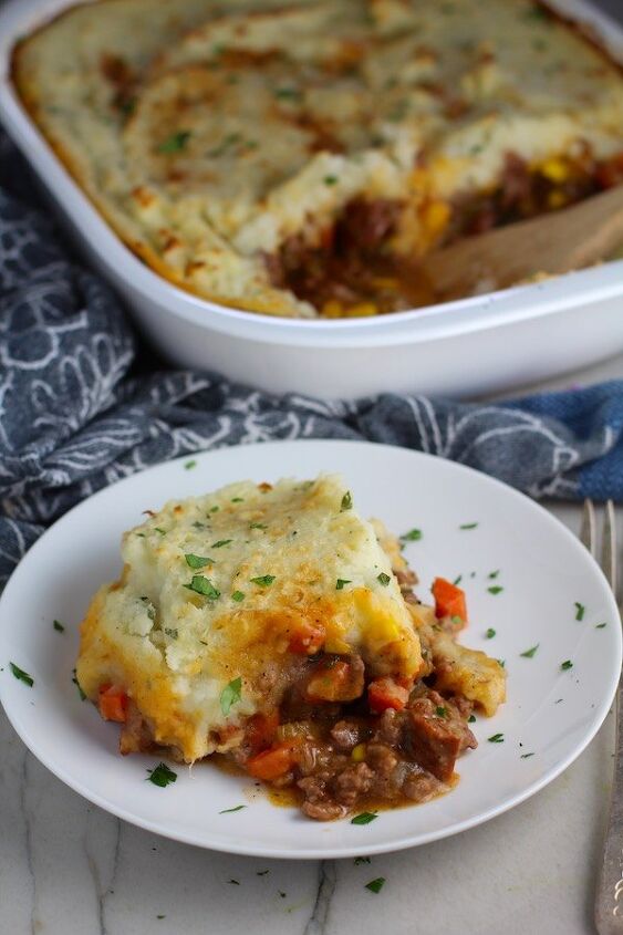 easy cottage pie recipe with chorizo, Piece of Cottage Pie on plate with dish in back This recipe has Spanish Chorizo and ground beef cooked in a rich and savory gravy with veggies and herbs Creamy mashed potatoes sit on top with manchego parmesan and garlic dinnerideas cottagepie shepherdspie