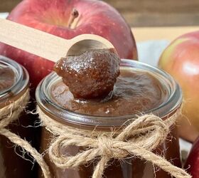 easy crockpot apple butter, Easy crockpot apple butter on a small wood spoon with a jar of apple butter under it
