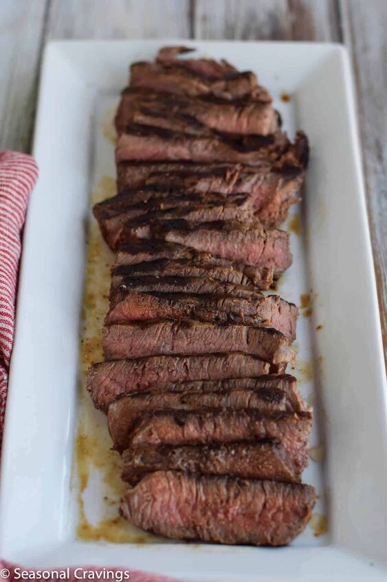 tender london broil, london broil round steak sliced on a white plate