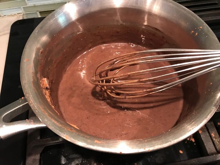 Sweetened evaporated milk and chocolate being whisked in a pot This Brigadeiro Recipe is based on traditional Brazilian chocolate dessert truffles rolled in sprinkles You won t believe how easy they are to make