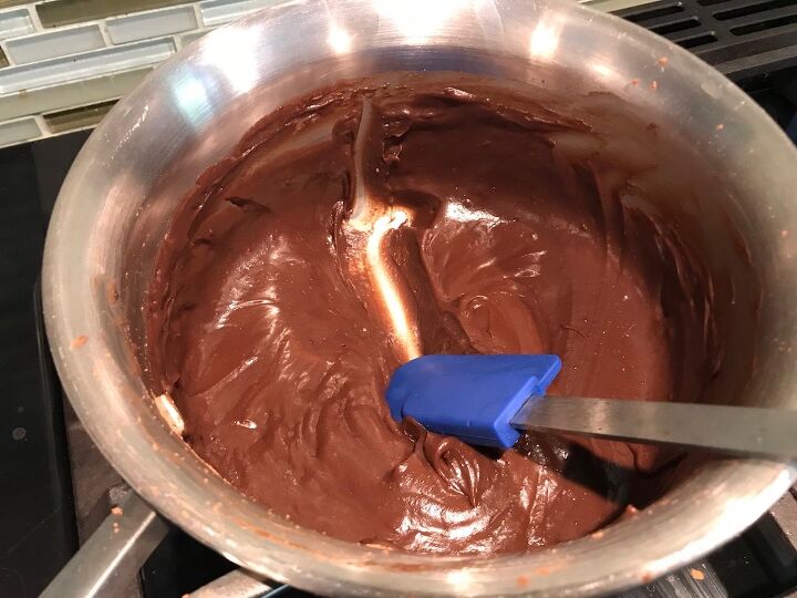 Evaporated milk and chocolate combined and thick in a pan being separated with a spatula This Brigadeiro Recipe is based on traditional Brazilian chocolate dessert truffles rolled in sprinkles You won t believe how easy they are to make