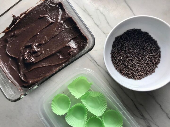 Dish with brigadeiro spread out with bowl of sprinkles next to it and container with green paper cups This Brigadeiro Recipe is based on traditional Brazilian chocolate truffles rolled in sprinkles You won t believe how easy they are to make