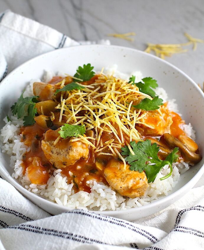 brazilian chicken stroganoff recipe, Brazilian Chicken Stroganoff in a tomato based sauce in a bowl over white rice with cilantro garnish and thin potato sticks on top This is an easy 30 minute dinner with a tomato based sauce cream and mushrooms all over rice