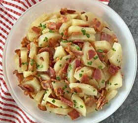 warm potato salad recipe with bacon, Warm potato salad in a white serving dish ready to eat with a red and white napkin tucked in on the left side