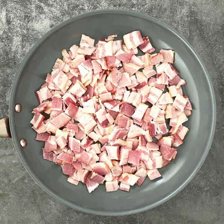 warm potato salad recipe with bacon, A pile of chopped uncooked bacon in a large gray skillet