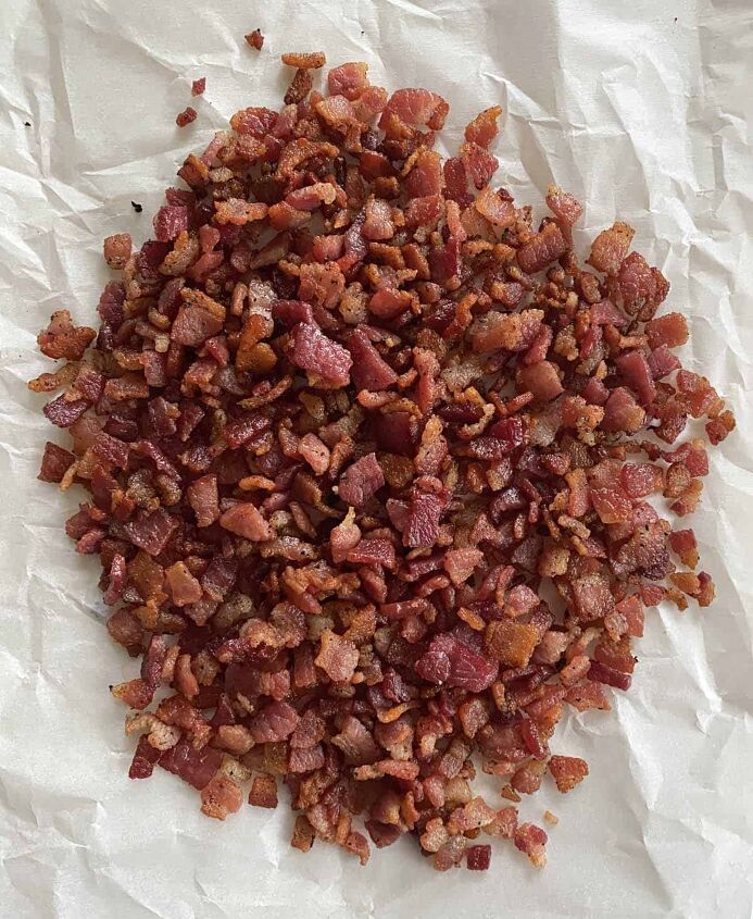 smoked baked beans with bacon and brown sugar, A pile of freshly cooked bacon bits on a piece of parchment paper