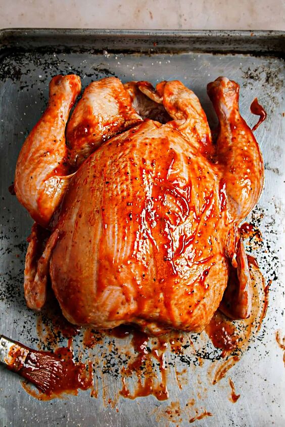 chipolte raspberry bbq whole chicken, Whole Chicken with Chipotle Raspberry BBQ Sauce on a baking tray ready to be grilled