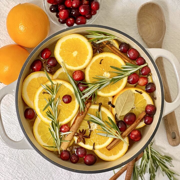 roasted rosemary cashews, A DIY simmer pot with oranges cinnamon sticks cranberries rosemary and spices in a cast iron pot