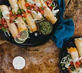air fryer cheesy potato taquitos, homemade air fryer potato stuffed taquitoes piled onto plated with a variety of toppings