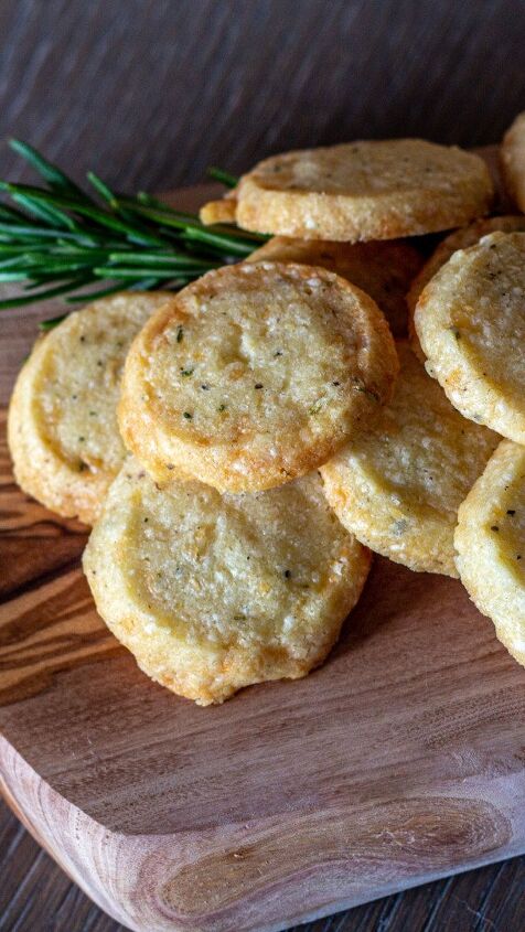 smoky cheddar crackers the perfect holiday appetizer, Cheddar cheese crackers on an olive wood board with a sprig of rosemary