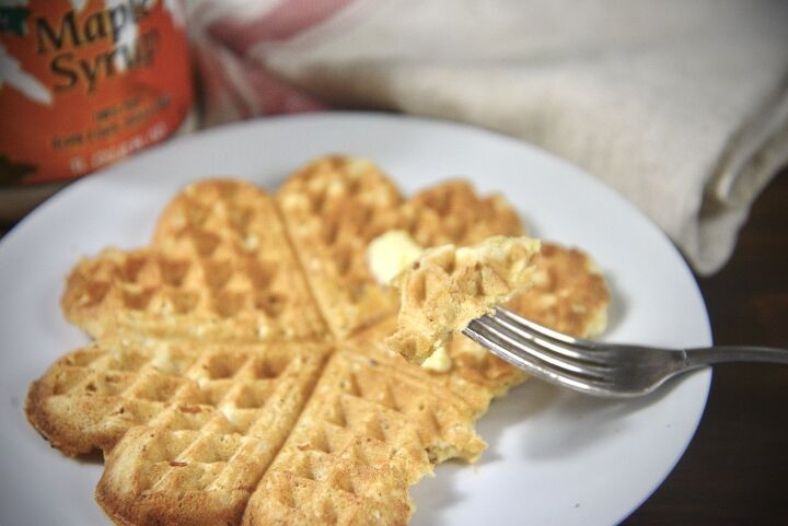 easy cast iron sourdough waffles, sourdough waffle on plate with maple syrup in background