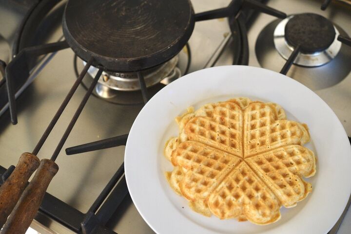 easy cast iron sourdough waffles, sourdough waffles on plate with cast iron waffle maker