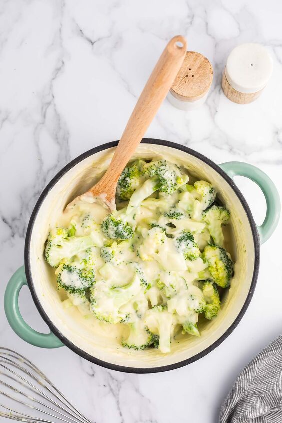 cheesy broccoli au gratin recipe, Broccoli florets being tossed with the cheese sauce